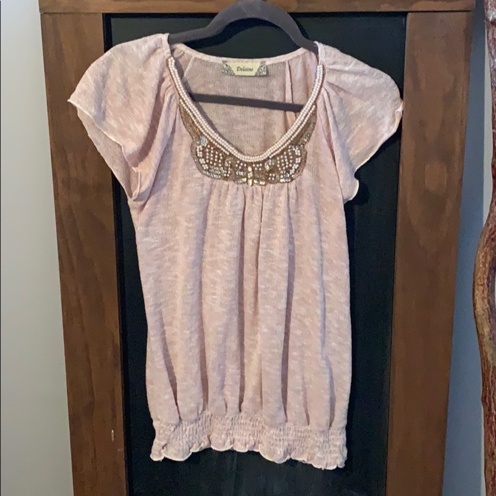 Flutter sleeve sweater with embellishment.